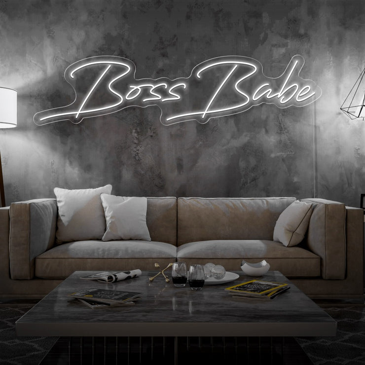cold white boss babe neon sign hanging on living room wall