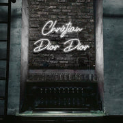 cold white christian dior dior neon sign hanging on bar wall