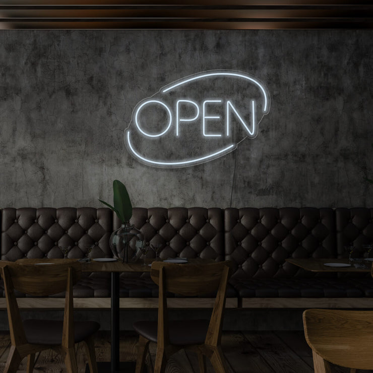 cold white open neon sign hanging on restaurant wall