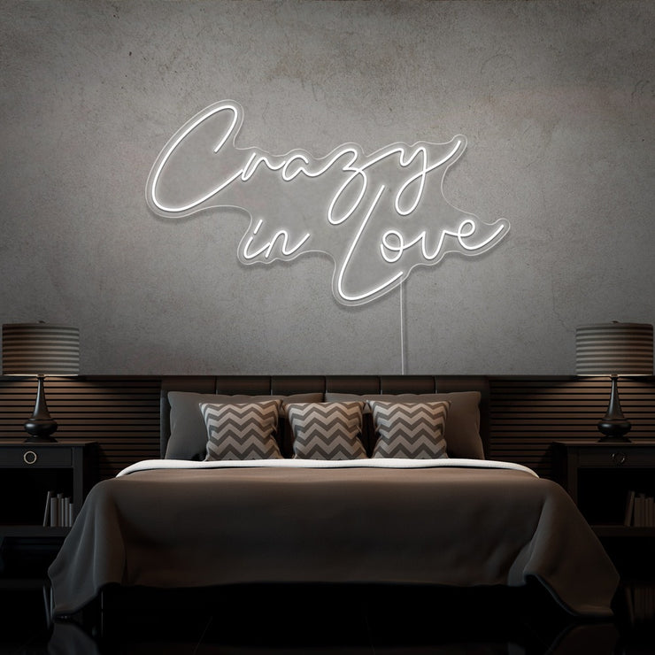 cold white crazy in love neon sign hanging on bedroom wall