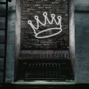 cold white crown neon sign hanging on bar wall