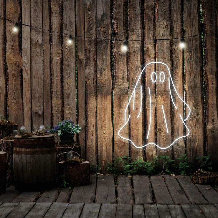 cold white draped ghost neon sign hanging on timber wall
