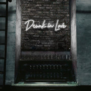 cold white drunk in love neon sign hanging on bar wall