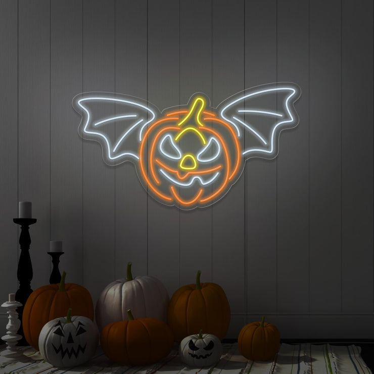 cold white flying pumpkin neon sign hanging on wall above pumpkins