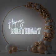 cold white happy birthday neon sign hanging inside gold hoop balloon backdrop
