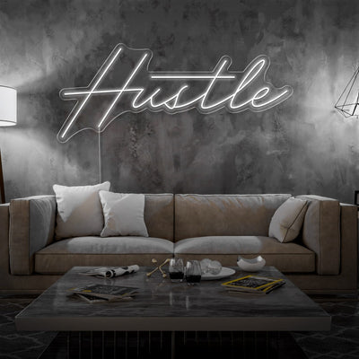 cold white hustle neon sign hanging on living room wall