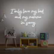 cold white I only love my bed and my momma I'm sorry neon sign hanging on kids wall