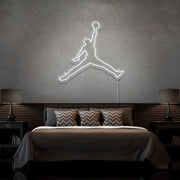 cold white jordan jumpman neon sign hanging on bedroom wall