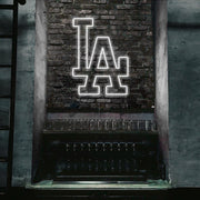 cold white LA neon sign hanging on bar wall