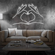 cold white love hands neon sign hanging on living room wall