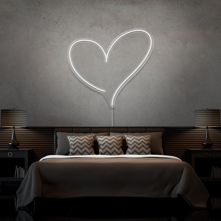 cold white love heart neon sign hanging on bedroom wall