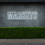 cold white markets neon sign hanging on outside wall