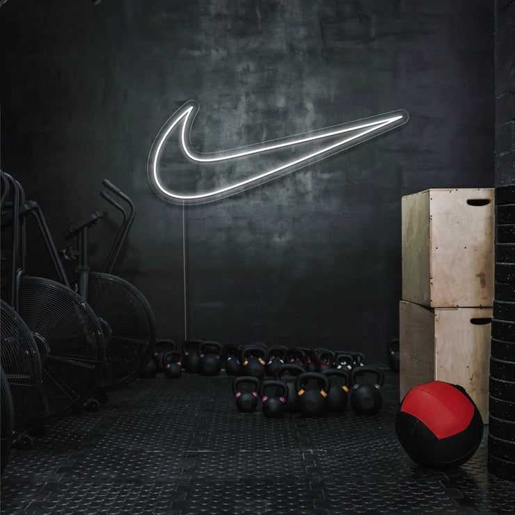 cold white nike swoosh neon sign hanging on gym wall