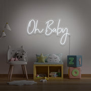 cold white oh baby neon sign hanging on kids bedroom wall