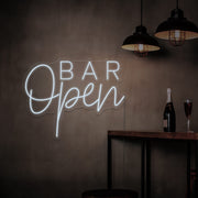 cold white open bar neon sign hanging on bar wall