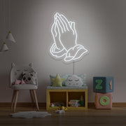 cold white praying hands neon sign hanging on kids bedroom wall