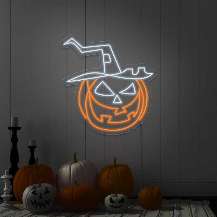 cold white pumpkin hat neon sign hanging on wall next to pumpkins