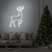 cold white reindeer neon sign hanging on living room wall next to christmas tree