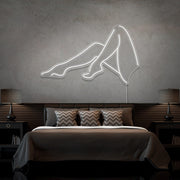 cold white sexy legs neon sign hanging on bedroom wall