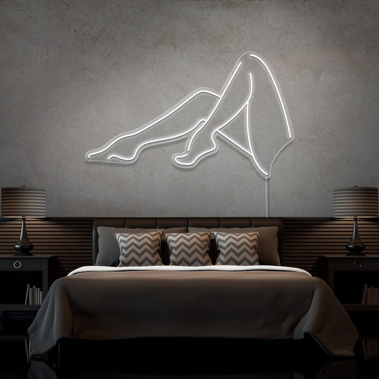cold white sexy legs neon sign hanging on bedroom wall