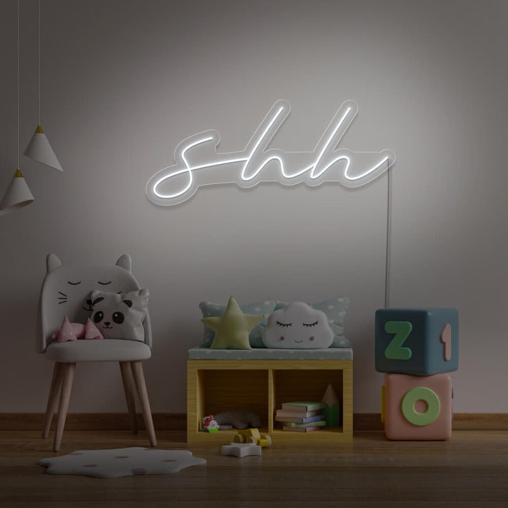cold white shh neon sign hanging on kids bedroom wall