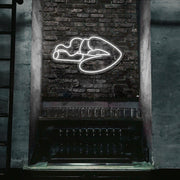 cold white smoking lips neon sign hanging on bar wall