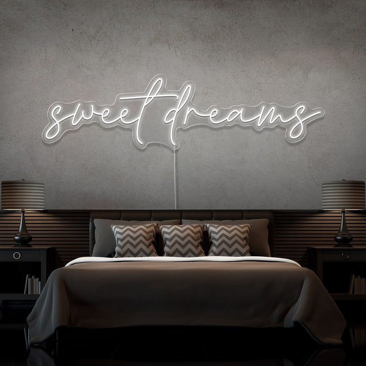 cold white sweet dreams neon sign hanging on bedroom wall