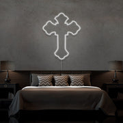 cold white tupac cross neon sign hanging on bedroom wall