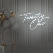 cold white twenty one neon sign hanging on wall with balloons