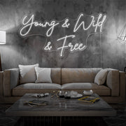 cold white young and wild and free neon sign hanging  on living room wall