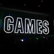 cold white games neon sign hanging at outdoor event