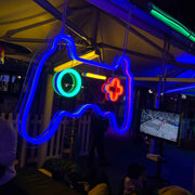 multi coloured gaming controller neon sign hanging on marquee at outdoor event