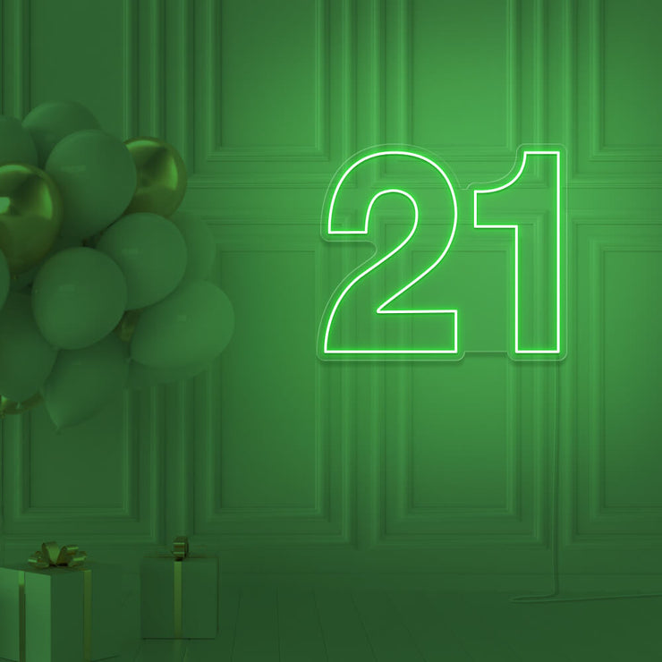 green  21 neon sign hanging on wall with balloons