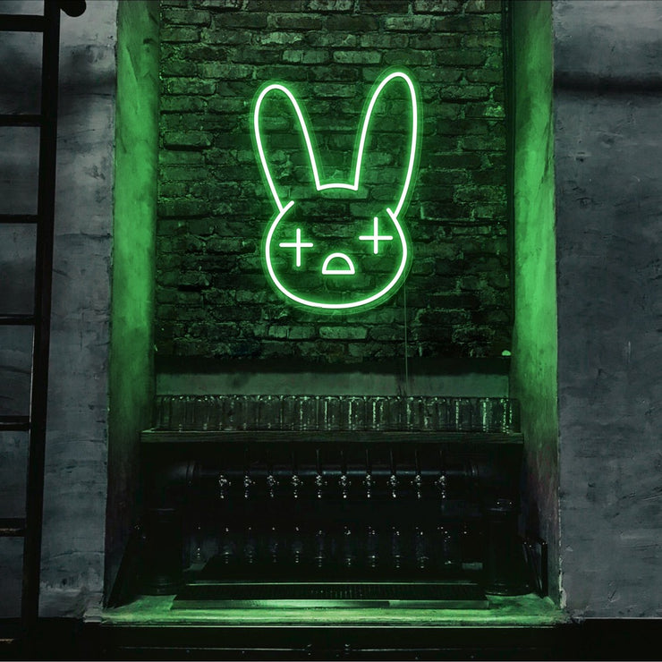 green bad bunny neon sign hanging on bar wall