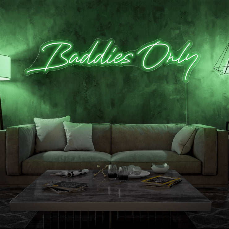 green baddies only neon sign hanging on living room wall