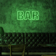 green bar neon sign hanging on bar wall