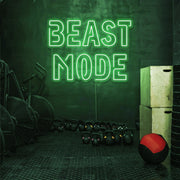 green beast mode neon sign hanging on gym wall