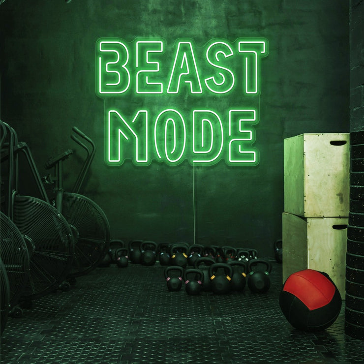 green beast mode neon sign hanging on gym wall