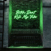 green bitch don't kill my vibe neon sign hanging on bar wall