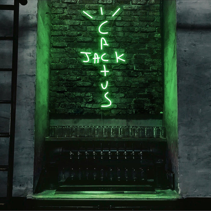 green cactus jack neon sign hanging on bar wall