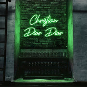 green christian dior dior neon sign hanging on bar wall