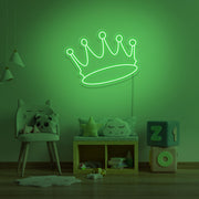 green crown neon sign hanging on kids bedroom wall