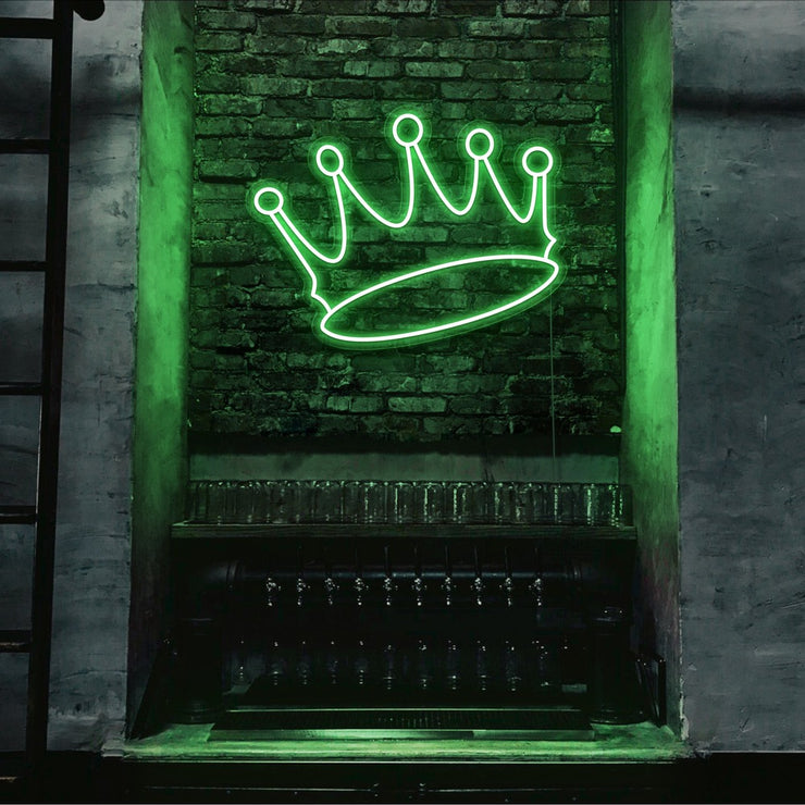 green crown neon sign hanging on bar wall