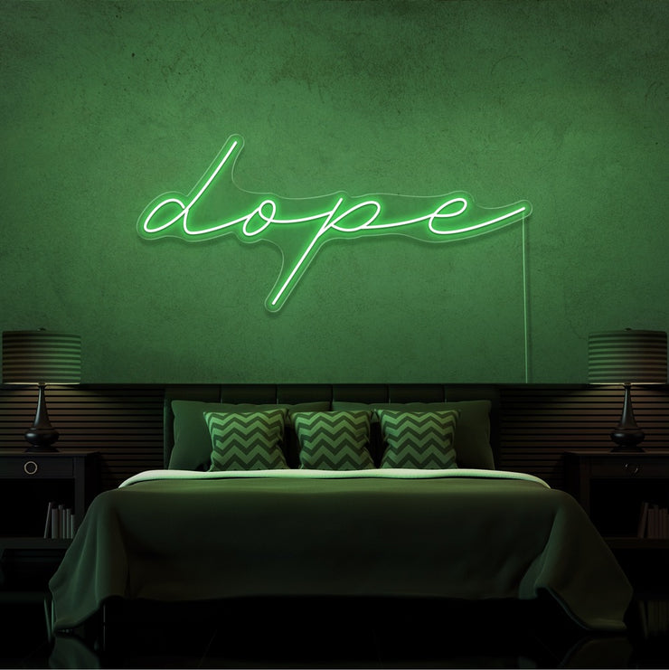 green dope cursive neon sign hanging on bedroom wall