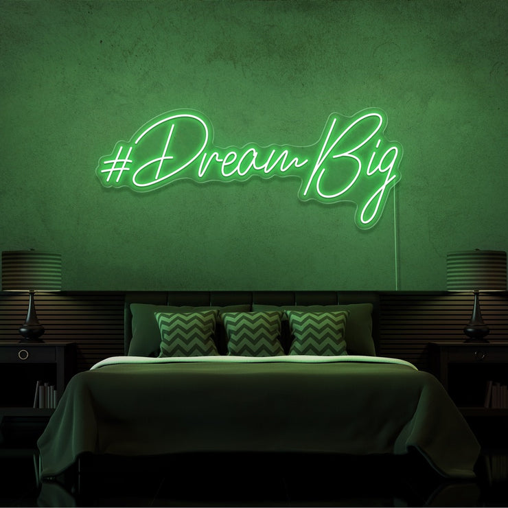 green dream big neon sign hanging on bedroom wall