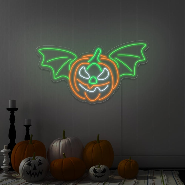 green flying pumpkin neon sign hanging on wall above pumpkins