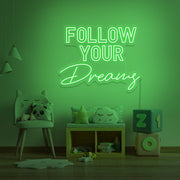 green follow your dreams neon sign hanging on kids bedroom wall