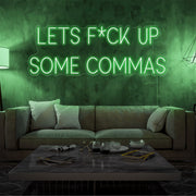 green lets fuck up commas neon sign hanging on living room wall
