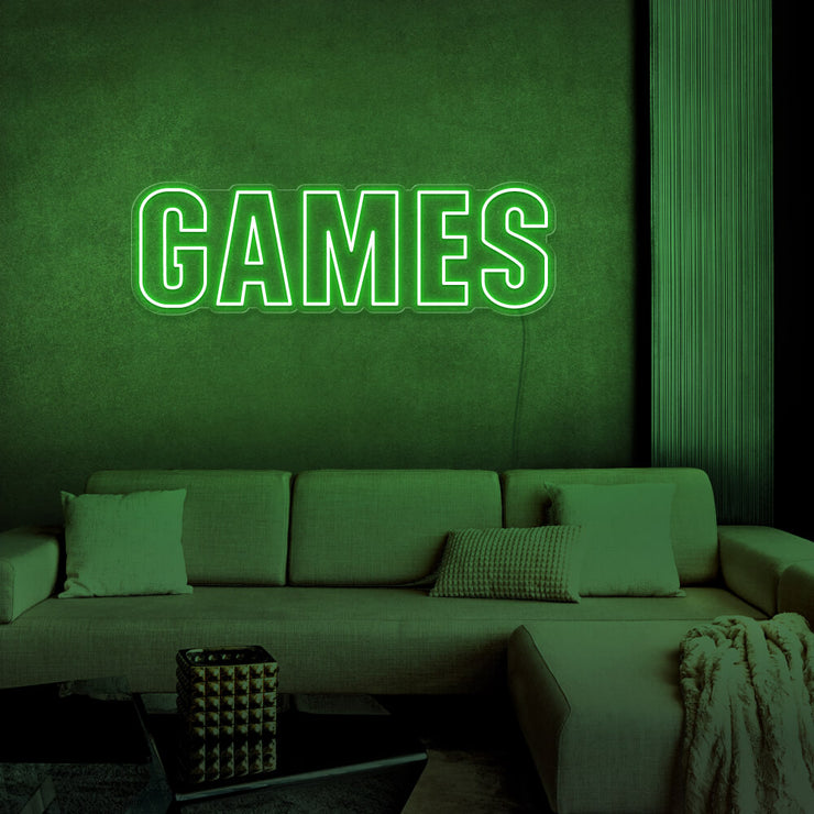 green games neon sign hanging on games room wall