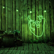 green ghost neon sign hanging on timber wall